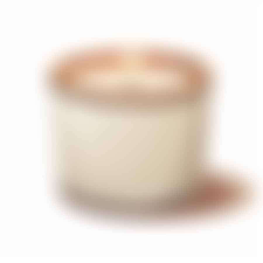 A hardened soy wax candle with a trimmed wick